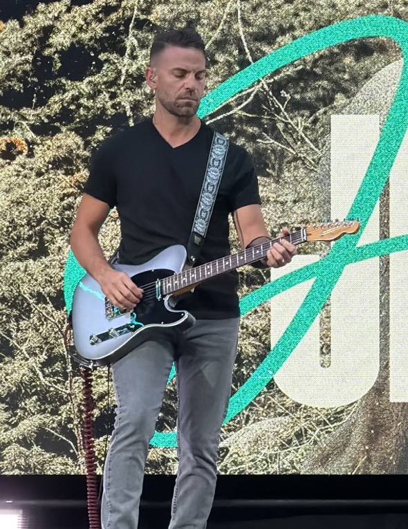 j.Andrew.White playing guitar on stage